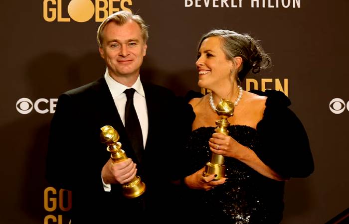 Christopher Nolan and his wife Emma Thomas with Golden Globes for Oppenheimer