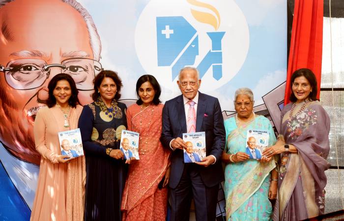 Prathap Reddy and his family showcasing The Apollo Story book